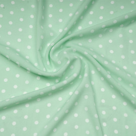 Tissu crêpe vert pastel à motif pois blanc