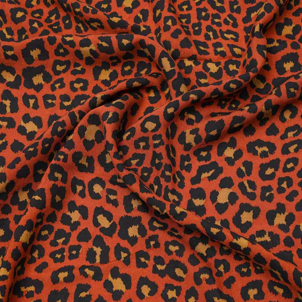 Tissu viscose orange rust à motif léopard noir et caramel |Pretty Mercerie | mercerie en ligne