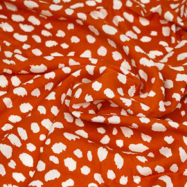 Tissu viscose spicy orange à motif imprimé pois irrégulier blanc