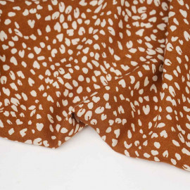 Tissu viscose rust à motif léopard écru
