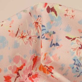 Tissu coton rose pâle à motif floral orange et bleu